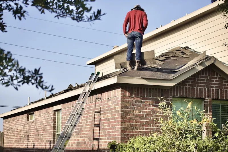 Professional roofer working on a residential roof in Chino